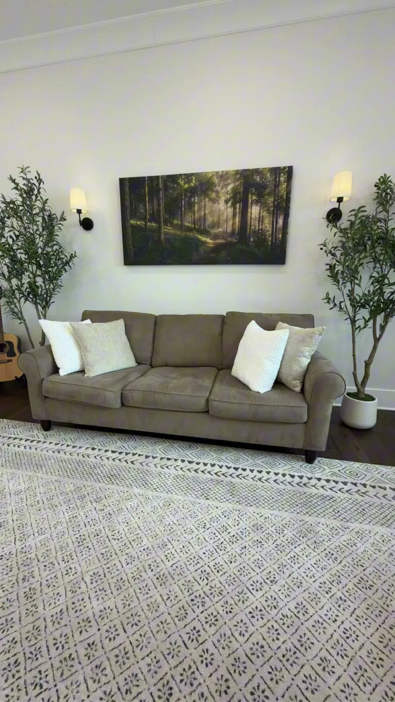 Clock Canvas sunlit forest canvas between wall sconces in a customer's living room